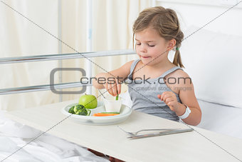 Girl having healthy food in hospital