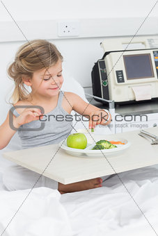 Sick girl having breakfast in hospital