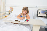 Sick girl coloring book in hospital