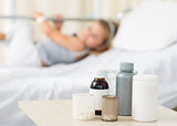 Medicines on table with girl in hospital