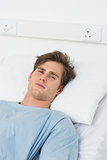 Male patient lying in hospital bed