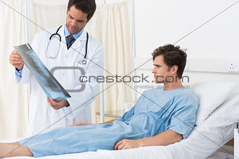 Doctor showing Xray report to patient