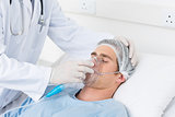 Doctor adjusting oxygen mask on patient