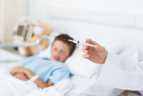 Doctor holding syringe with boy in hospital