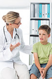 Doctor talking with boy in clinic