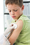 Boy receiving vaccination in arm