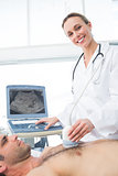 Doctor using ultrasound scan on male patient