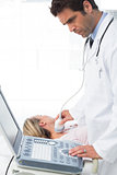 Doctor using sonogram on female patient