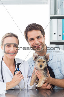 Vet and pet owner with puppy