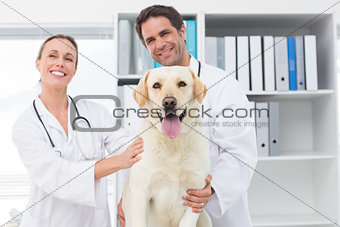 Happy veterinarians with dog