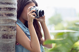 Young girl taking photographs outside