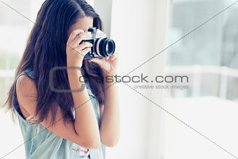 Stylish young photographer taking a photo