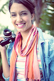 Cheerful photographer standing outside smiling at camera