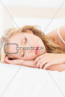 Natural young blonde lying on her bed sleeping
