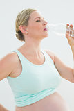Pregnant woman drinking bottle of water