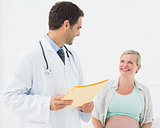 Happy pregnant woman having a check up with doctor