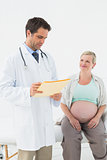 Cheerful pregnant woman having a check up with doctor