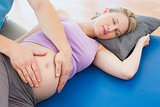 Peaceful pregnant woman having a relaxing massage