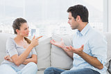 Couple having a serious argument on the couch