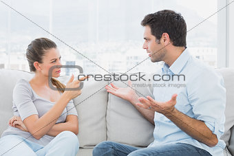 Couple having a serious argument on the couch