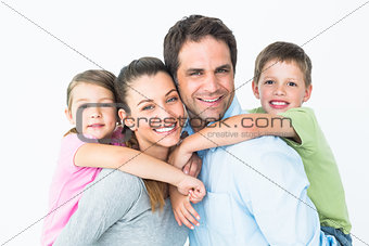 Happy young family looking at camera together