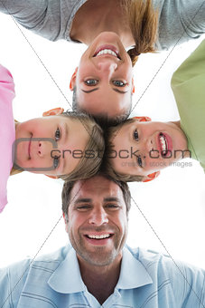 Cute family smiling down at camera together