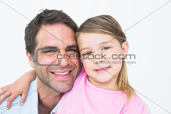 Cute father and daughter posing and smiling at camera together