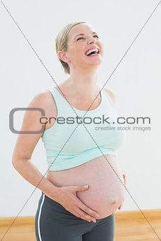 Blonde pregnant woman laughing