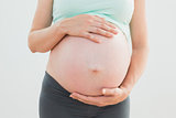 Pregnant woman holding her baby bump