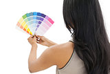Rear view of a woman looking at paint samples