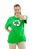 Smiling woman in recycling symbol t-shirt pointing at camera