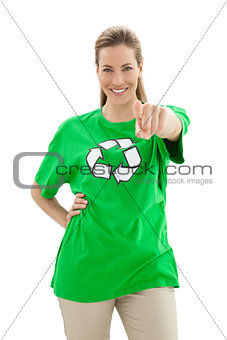 Smiling woman in recycling symbol t-shirt pointing at camera