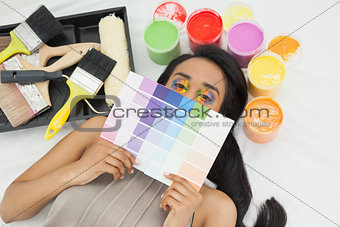 Woman with paint samples and paintbrush
