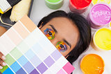 Portrait of a young woman with paint samples