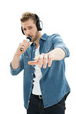Portrait of a young man singing into microphone