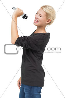 Beautiful young woman singing into a microphone