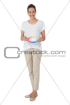 Full length of a young woman with paint samples