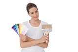 Young woman with paint samples and paintbrush