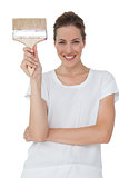 Portrait of a smiling woman with paintbrush