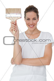 Portrait of a smiling woman with paintbrush