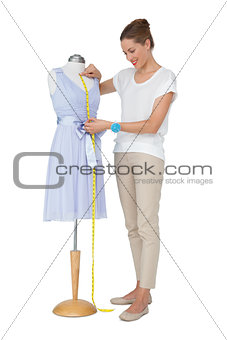Full length of a female fashion designer and mannequin