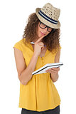 Portrait of a cool young woman writing in notepad
