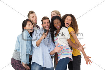 Group of happy people singing into microphone