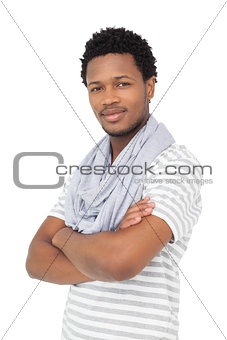 Portrait of a smiling young man with arms crossed