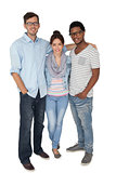 Full length portrait of three happy young people