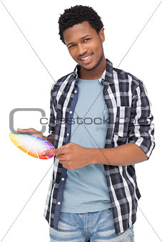 Portrait of a young man with paint samples