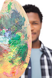 Close-up portrait of a male painter with palette