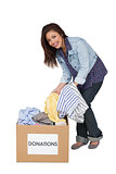 Portrait of a happy young woman with clothes donation