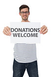 Portrait of a man holding a donation welcome note