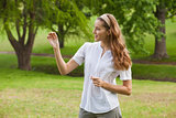 Woman holding a flower at park